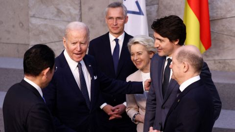 Japan's Prime Minister Fumio Kishida (left), U.S. President Joe Biden (second left) and Germany's Chancellor Olaf Scholz (right) speak with NATO Secretary General Jens Stoltenberg (center), European Commission President Ursula von der Leyen (third from right) and Canada's Prime Minister Justin Trudeau (second from right) before a G7 leaders' family photograph on March 24, 2022. 