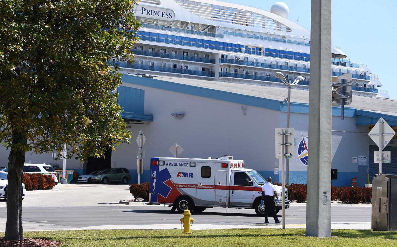 An ambulance transports a patient from the Coral Princess cruise ship docked at the Port of Miami, Florida, on April 4.