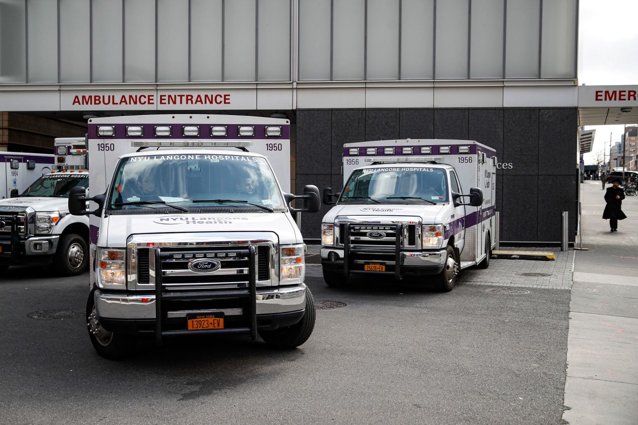 Ambulances sit outside the NYU A medical professional drives an ambulance away from the NYU Langone Hospital Emergency room entrance, Monday, March 16, 2020, in New York. New York leaders took a series of unprecedented steps Sunday to slow the spread of the coronavirus, including canceling schools and extinguishing most nightlife in New York City. (AP Photo/John Minchillo)