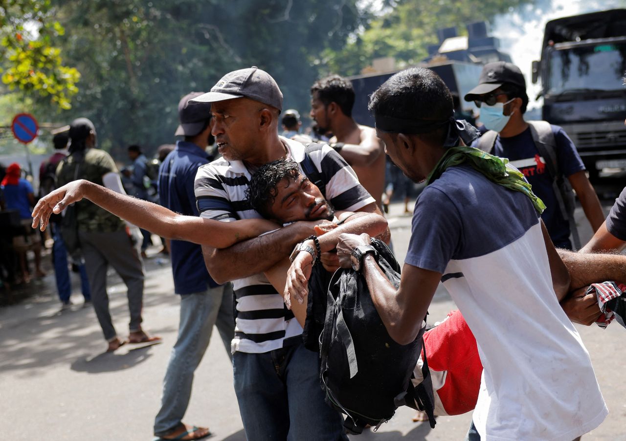 Demonstrators carry an injured person during a clash in front of?Sri?Lankan Prime Minister Ranil Wickremasinghe's office in Colombo,?Sri?Lanka, on July 13.