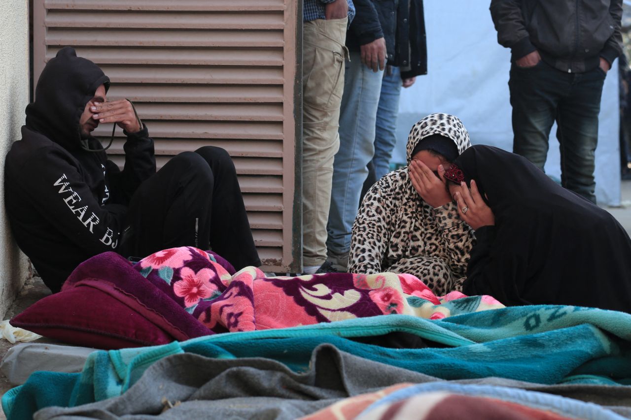 People mourn by the body of a family member in the courtyard of the Al-Aqsa Martyrs Hospital in Deir al-Balah, Gaza, on March 10, after he was killed in Israeli strikes on the makeshift Al-Mawasi camp for displaced people, west of Khan Younis.