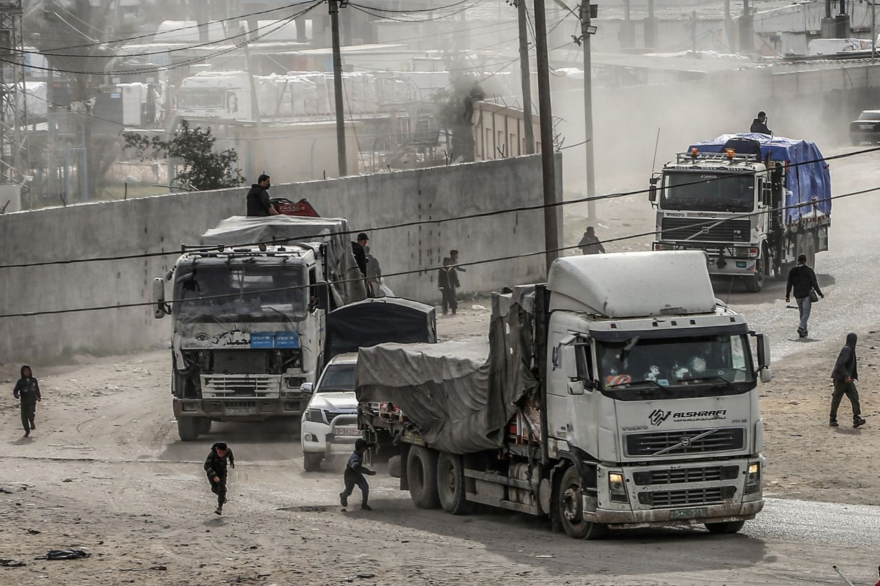 Trucks carrying humanitarian aid enter Gaza through the Kerem Shalom crossing border on January 17.