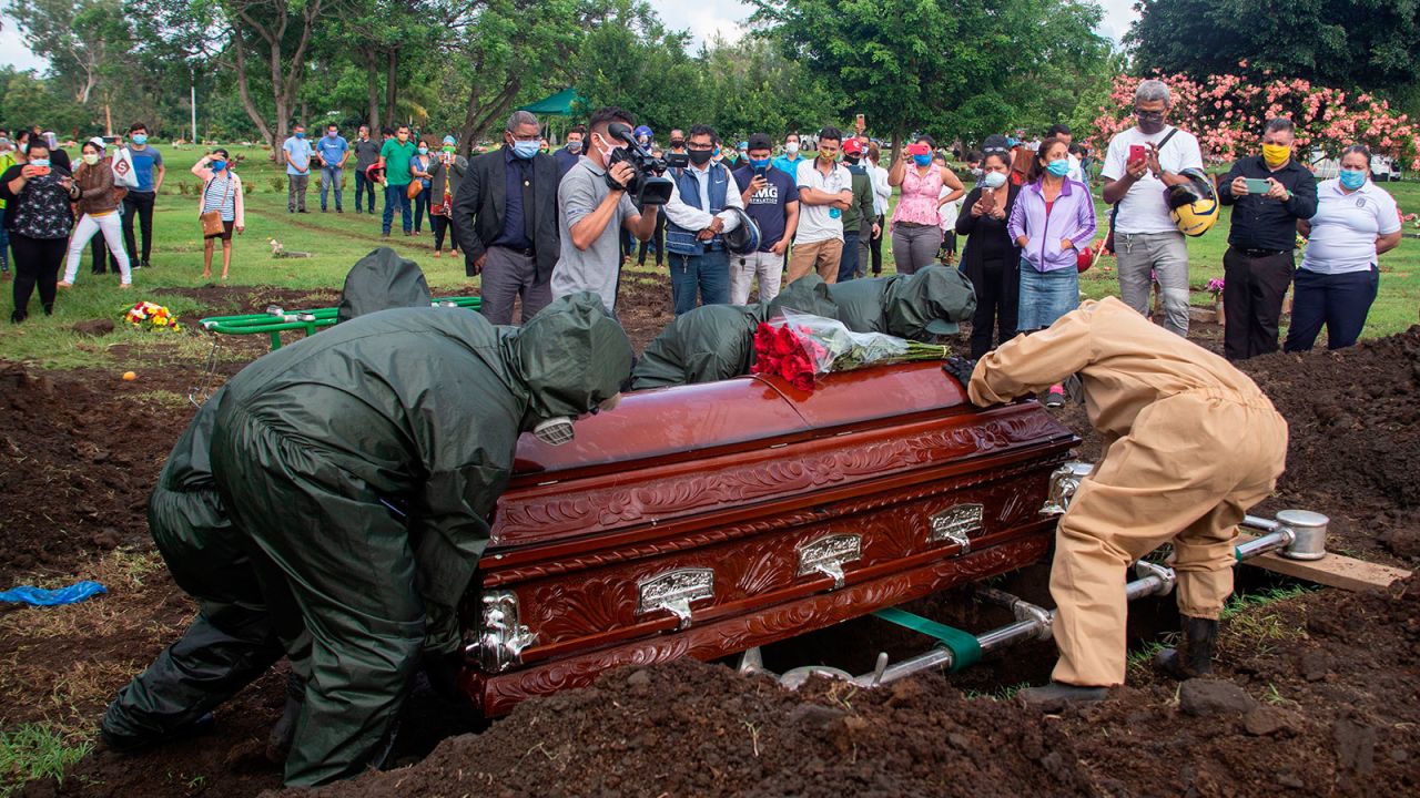 Gravediggers bury the coffin of a pastor, who allegedly died from Covid-19, during his funeral at the Jardines del Recuerdo Cemetery in Managua, Nicaragua on June 5.