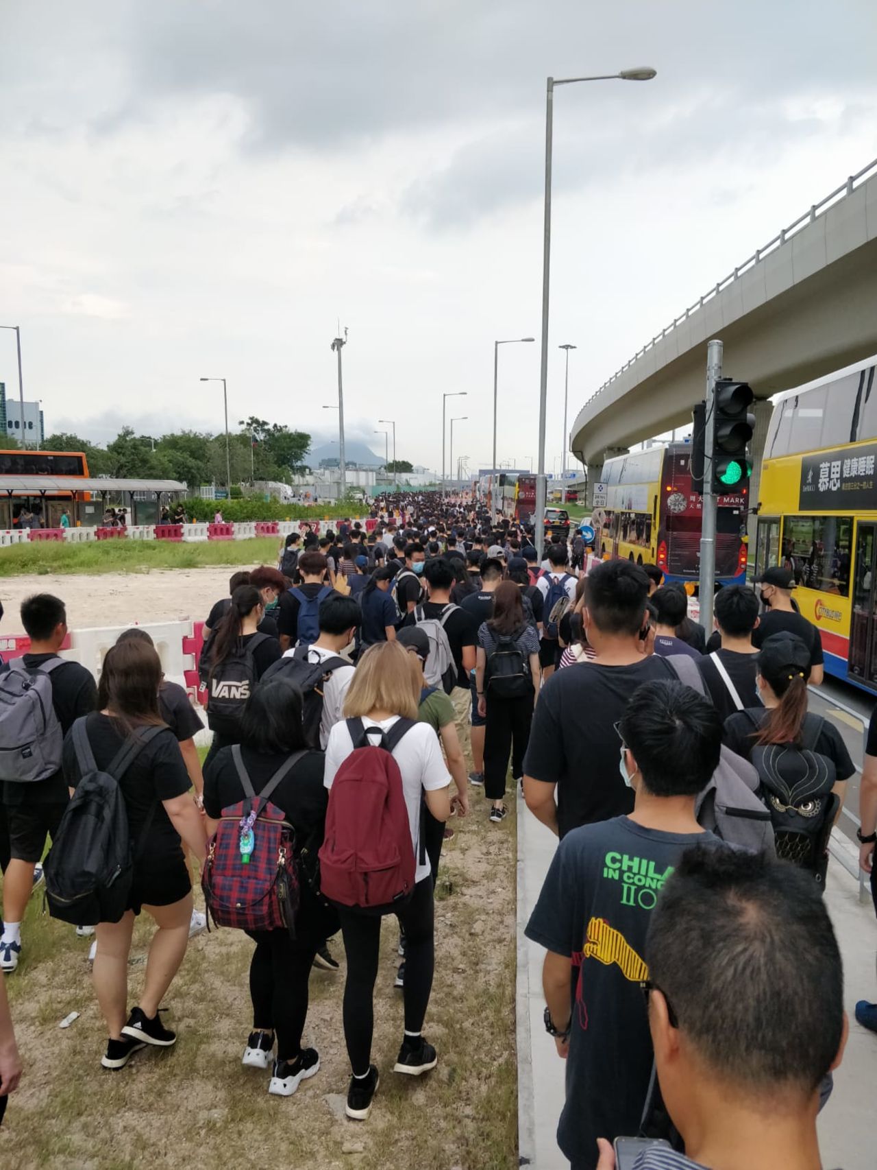 Crowds are seen walking toward the airport, where there are already thousands of demonstrators.