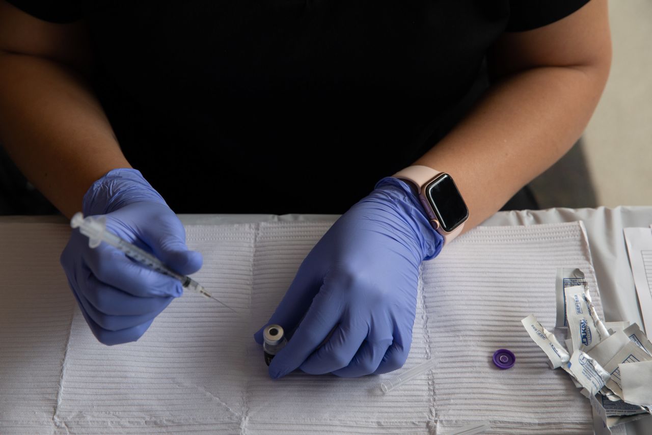 Oakland County Health Department emergency preparedness specialist Jeanette Henson fills syringes with doses of the Covid-19 vaccine on August 24, at the Southfield Pavilion in Southfield, Michigan. 