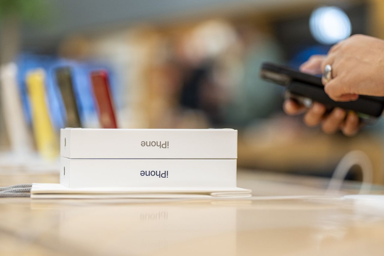 A customer purchases the new iPhone 15 in store on September 22, 2023 in Milan, Italy. 