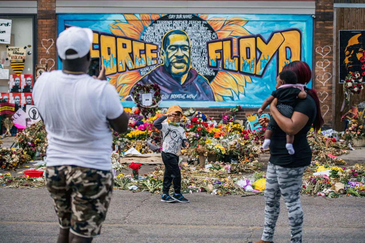 A family takes pictures in front of a mural of George Floyd on June 10, in Minneapolis, Minnesota. 