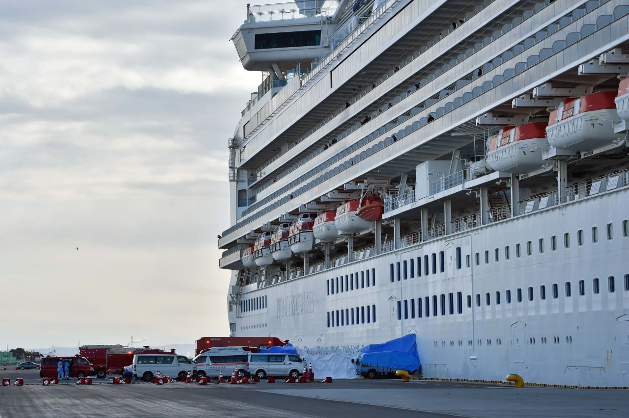 An ambulance waits for patients who tested positive for the coronavirus aboard the Diamond Princess cruise ship, docked at the Daikoku Pier Cruise Terminal in Yokohama, Japan on Thursday. 