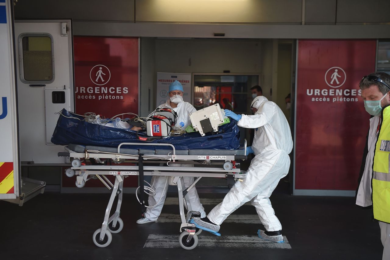 Medical staff carry a patient infected with  Covid-19 into Strasbourg hospital's emergency unit on November 6.