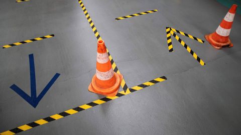 Cones and tape on the ground help employees of French automaker PSA Peugeot-Citroen to keep social distances required at the Poissy, France, plant on April 15.