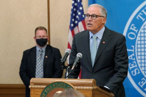 Washington Gov. Jay Inslee, right, speaks at a news conference on August 18 at the Capitol in Olympia, Washington.
