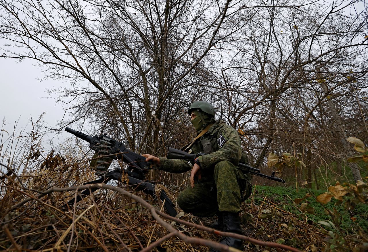 A Russian service member sits near an automatic grenade launcher at a combat position on the left bank of the Dnipro river in the?Zaporizhzhia?region, Ukraine, on November 26.