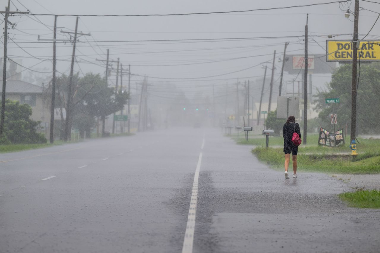 A person walks through a downpour as Hurricane Francine approaches the area on Wednesday in Houma, Louisiana. 