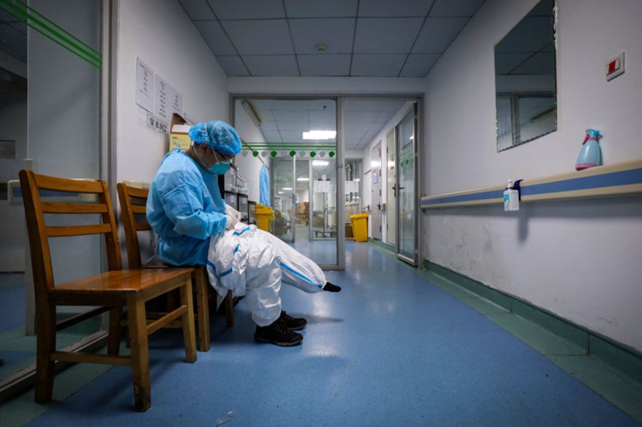 A doctor puts on a protective suit as he prepares to check on patients at Jinyintan Hospital designated for coronavirus patients, in Wuhan in central China's Hubei province on Sunday, February 16. 