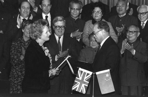 British Prime Minister Margaret Thatcher and Chinese Premier Zhao Ziyang, center right, exchange signed copies of the Hong Kong handover agreement to China in Beijing on December 19, 1984.