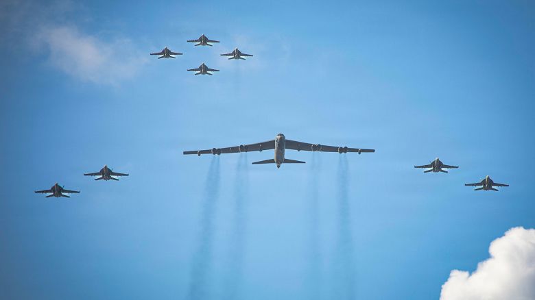 Eight F/A-18E/F Super Hornets, assigned to Strike Fighter Squadrons 31, 37, 87, and 213 from embarked Carrier Air Wing Eight aboard USS Gerald R. Ford, and a US Air Force B-52 Stratofortress operate as a joint force on November 13.
