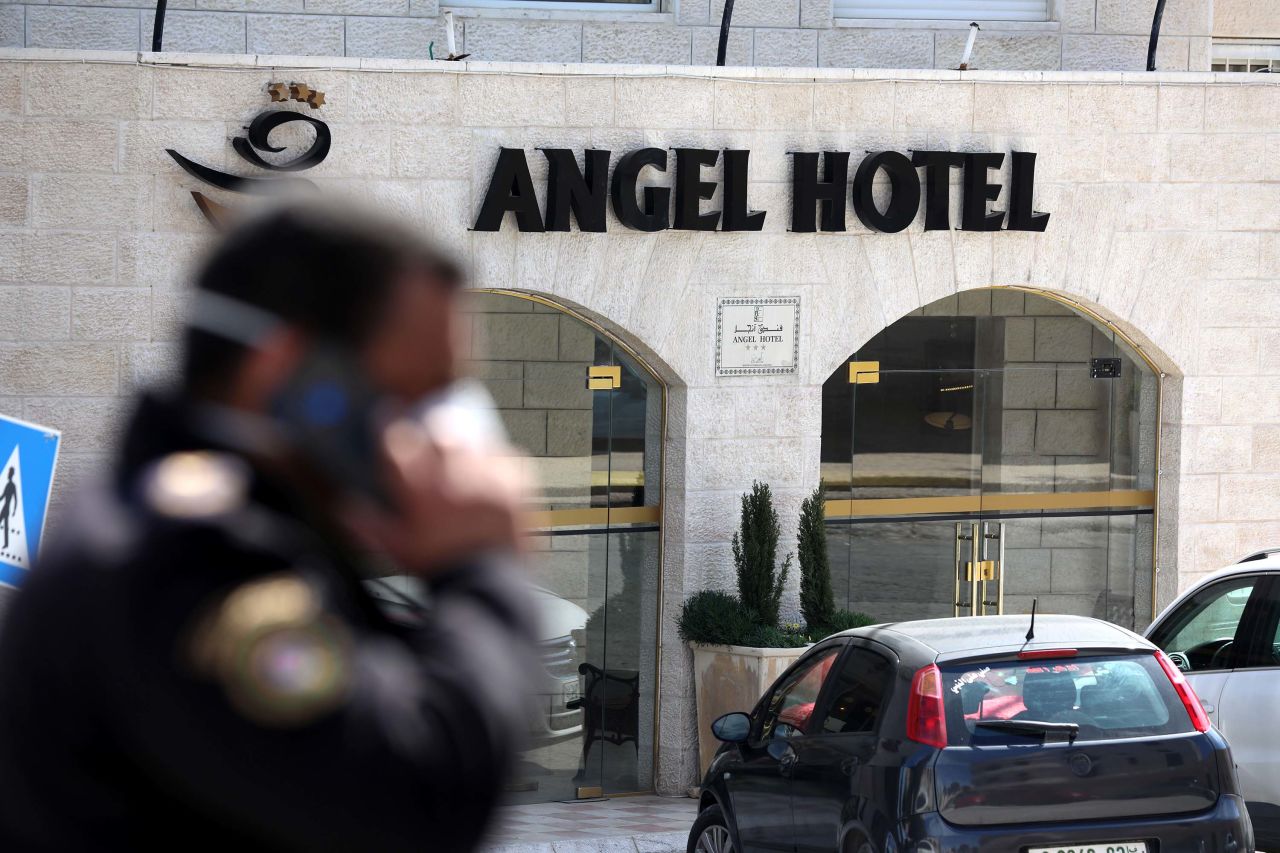 A police officer stands guard outside a quarantined hotel in Bethlehem, West Bank on Friday.