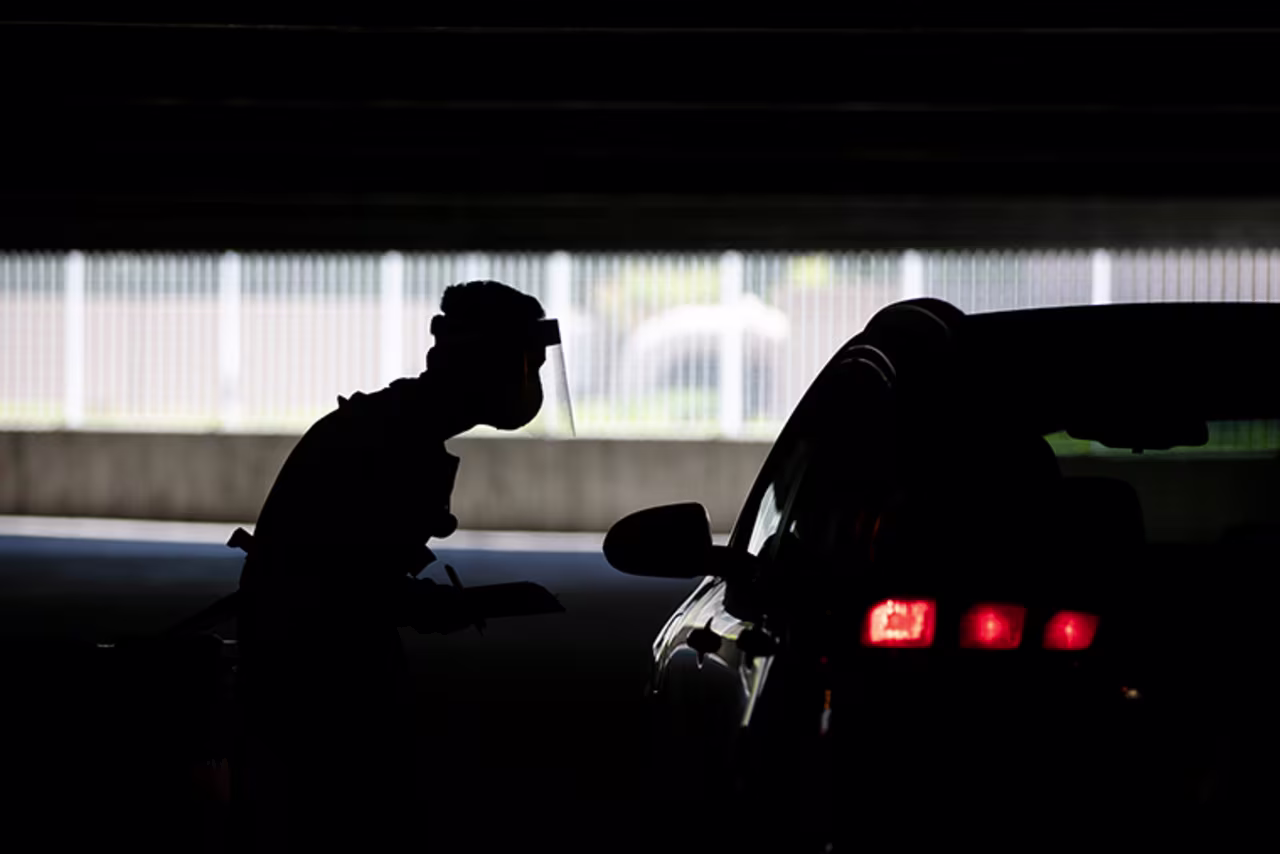 Physician assistant Calvin Tran works at a COVID-19 drive-through testing site set up at the Anaheim Convention Center in Anaheim, California, Thursday, July 16. 