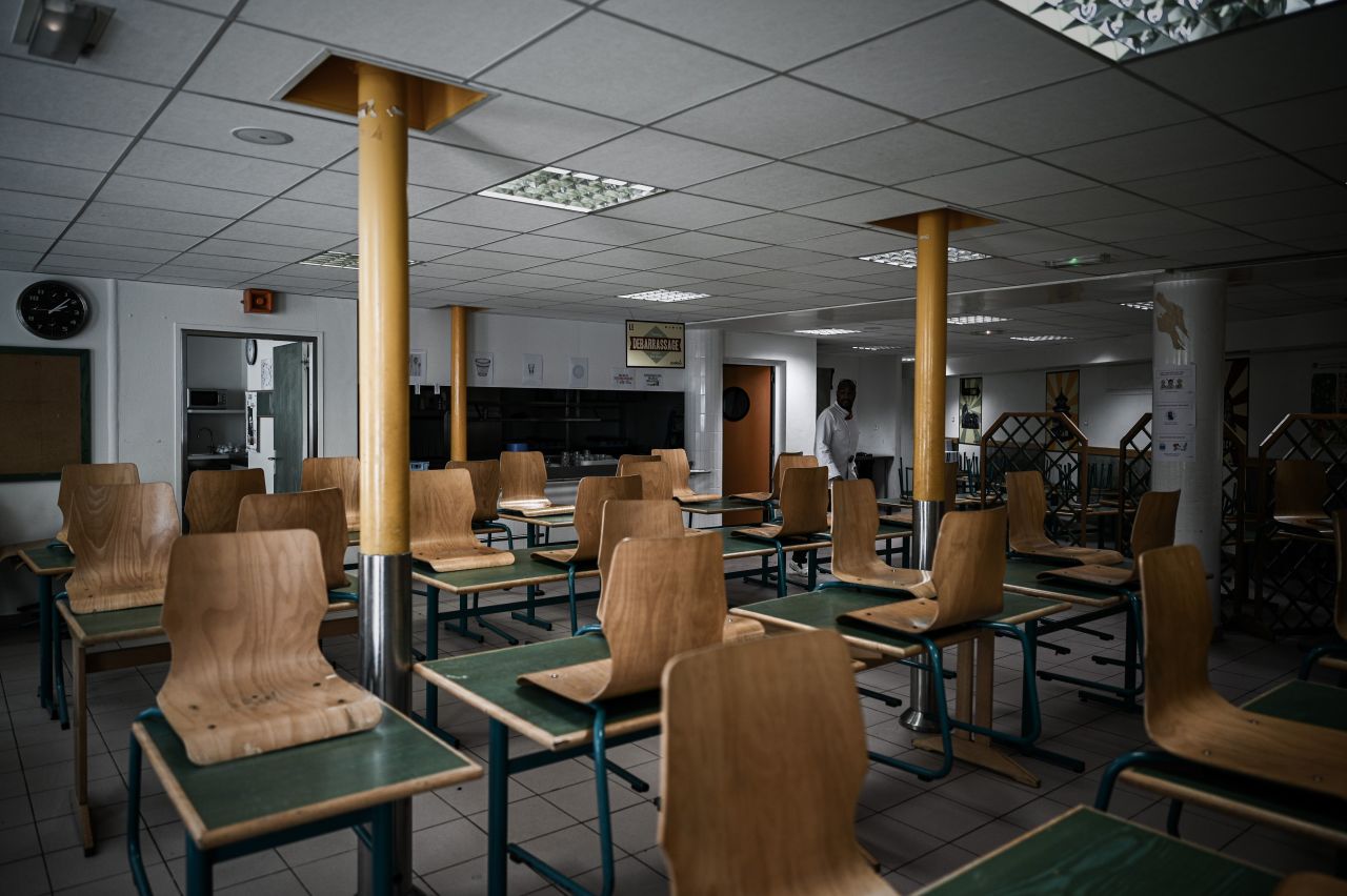 A staff member walks in the canteen of the private school Institut Sainte Genevieve prepared to respecting the social distance with only two children per table, in the French capital Paris on May 7, 2020, as the schools in France are to gradually reopen from May 11, when a partial lifting of restrictions due to the Covid-19 pandemic caused by the novel coronavirus will come into effect. (Photo by PHILIPPE LOPEZ / AFP) (Photo by PHILIPPE LOPEZ/AFP via Getty Images)