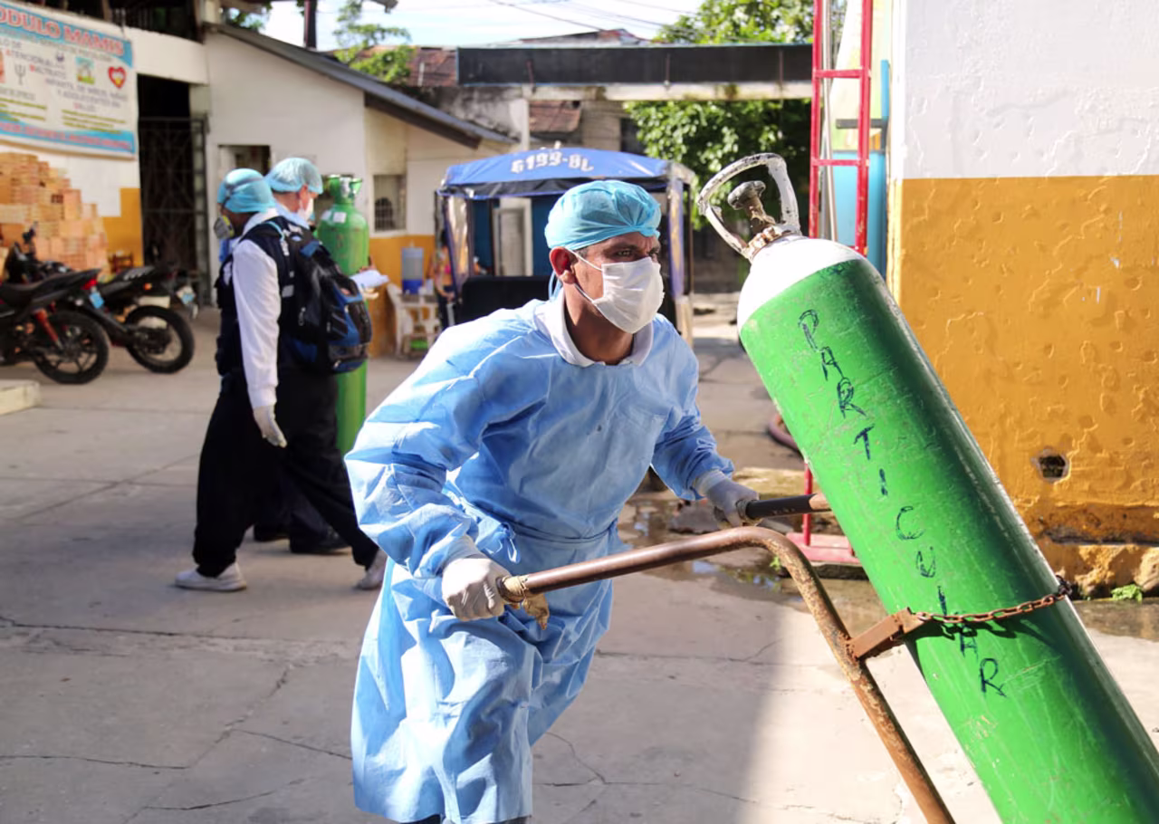 A health worker transports an oxygen tank at the Cesar Garayar support hospital in Iquitos, Peru, on May 22. 