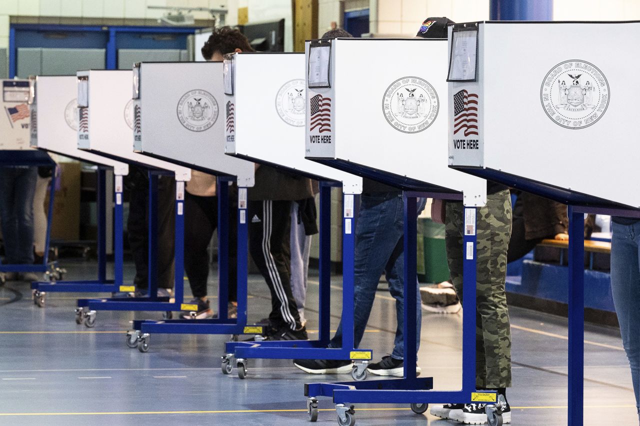 Voters marking their ballot in a privacy booth at West Side High School during early voting in New York City on November 6.