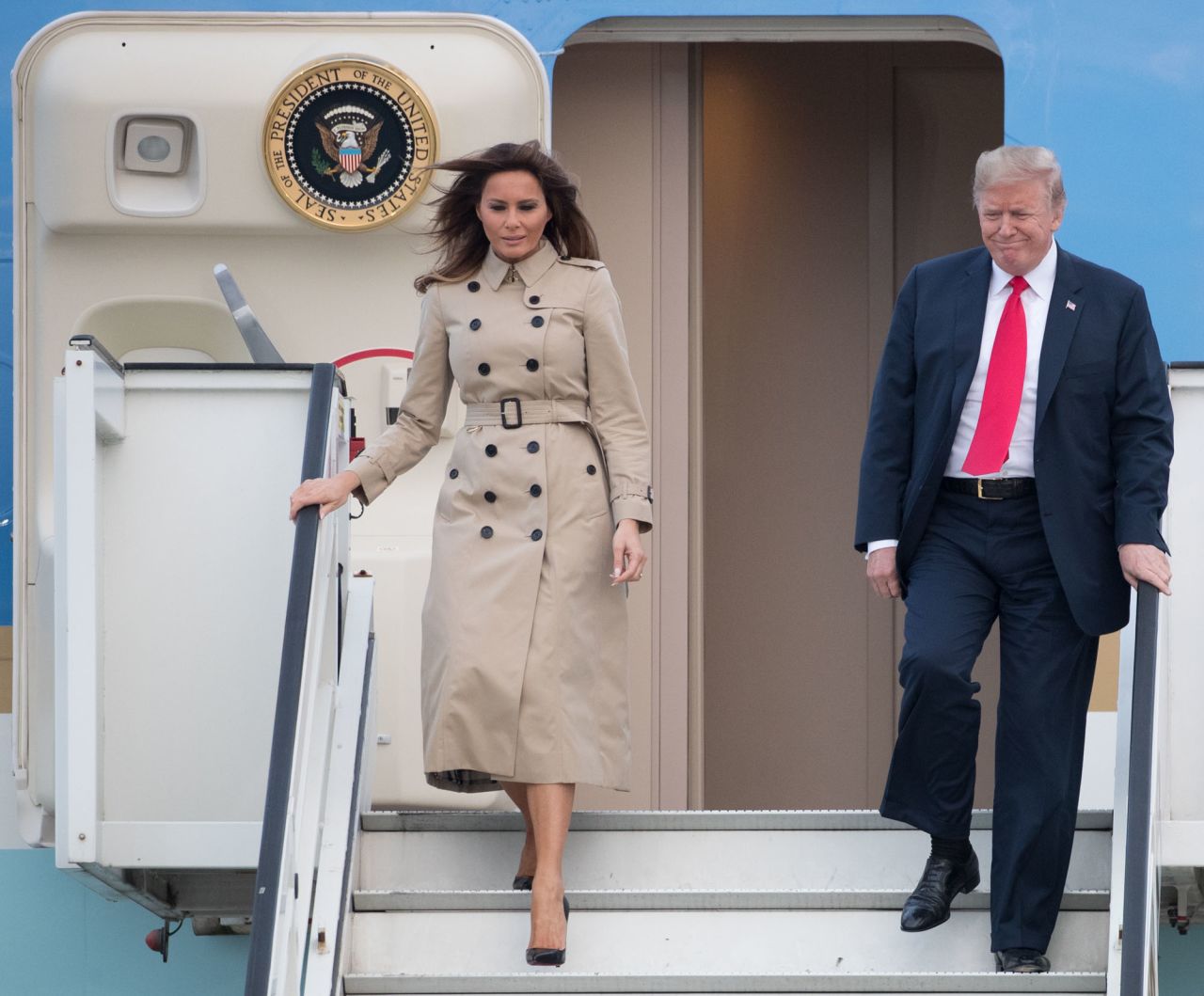 President Trump and Melania Trump disembark from Air Force One as they arrive in Brussels on Tuesday