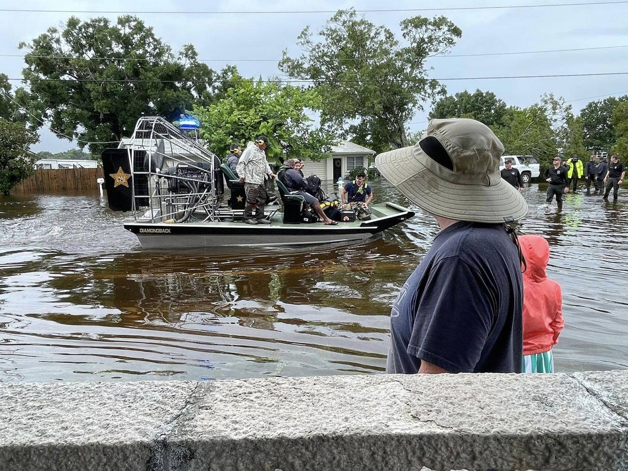 First responders help people evacuate their homes in Sarasota, Florida, on Monday. 