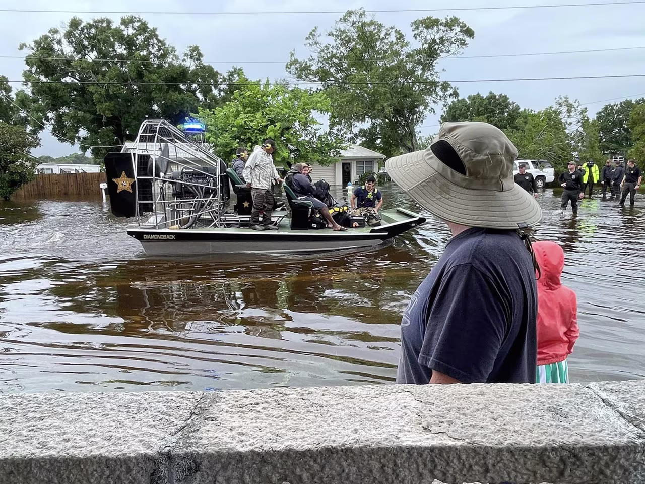 First responders help people evacuate their homes in Sarasota, Florida, on Monday. 