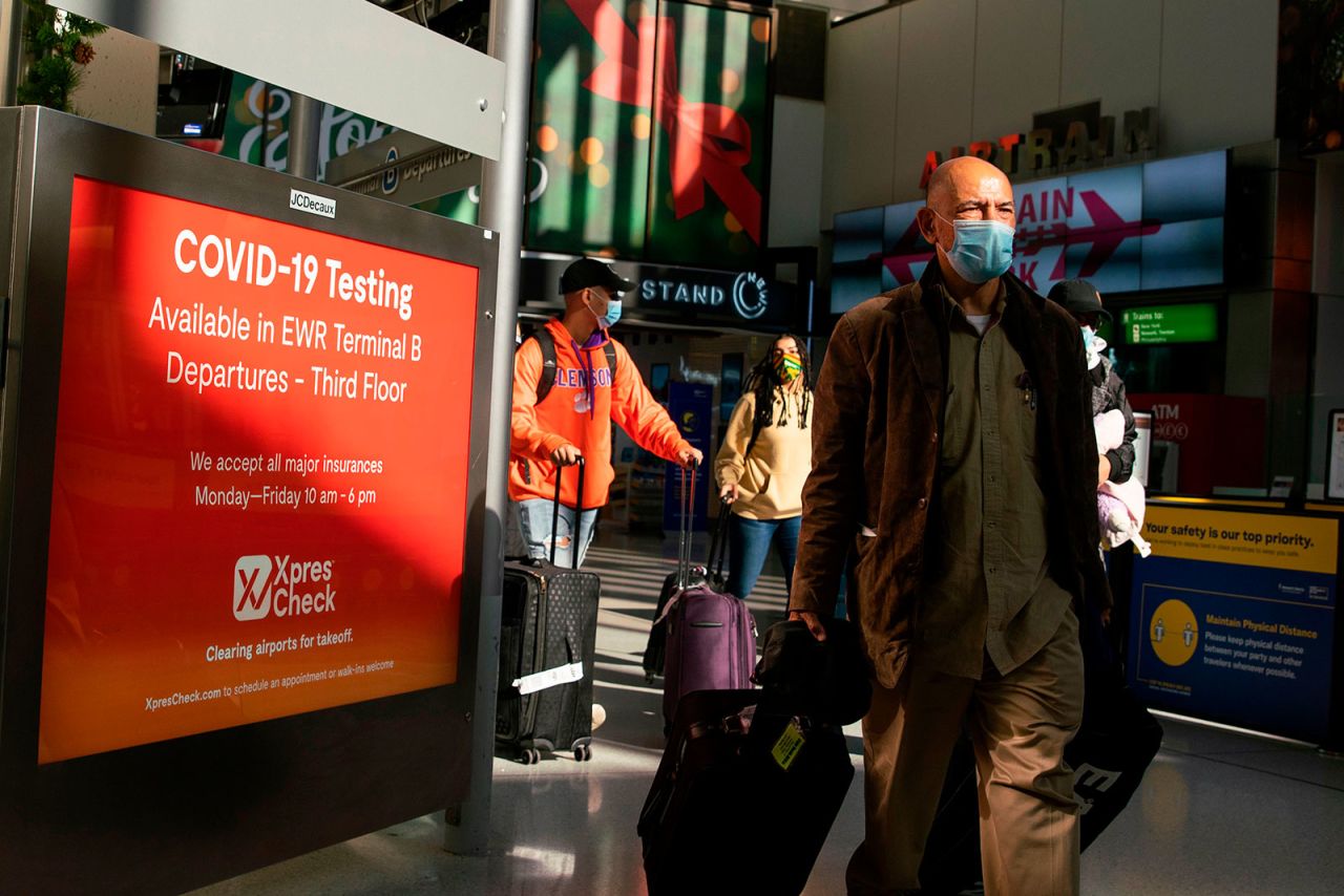 Travelers walk through Newark International Airport in Newark, New Jersey, on November 21.