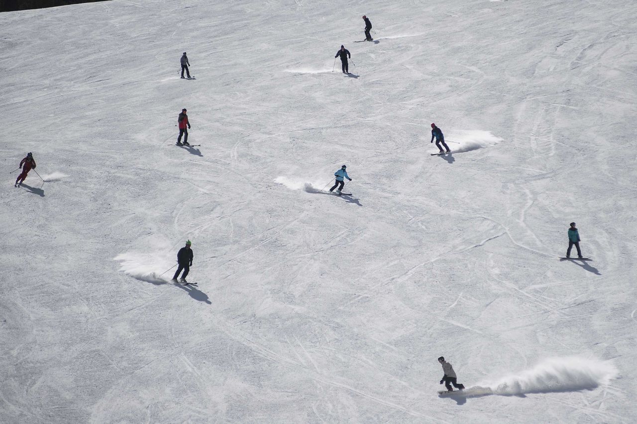 Skiers descend down a ski run at a Vail Resorts location in Vail, Colorado, in March 2018.