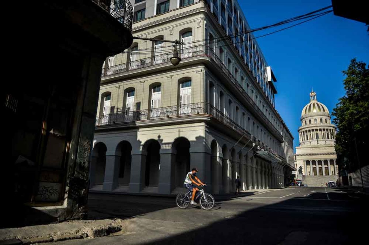 A man rides his bicycle along an empty street in Havana on May 19.