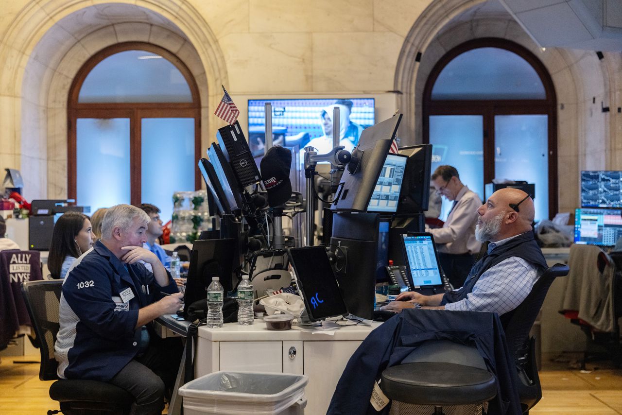 Traders work on the floor of the New York Stock Exchange on August 1.