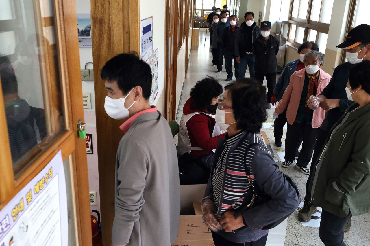 People wait in line to cast for their votes for the parliamentary elections at a polling station in Nonsan, South Korea, on April 15.