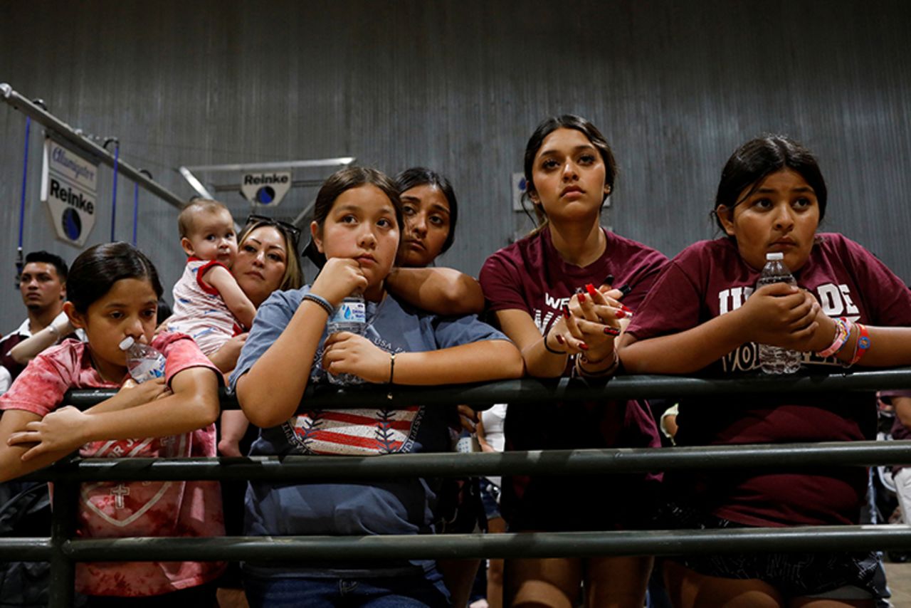 Children look on during the vigil at Uvalde County Fairplex.