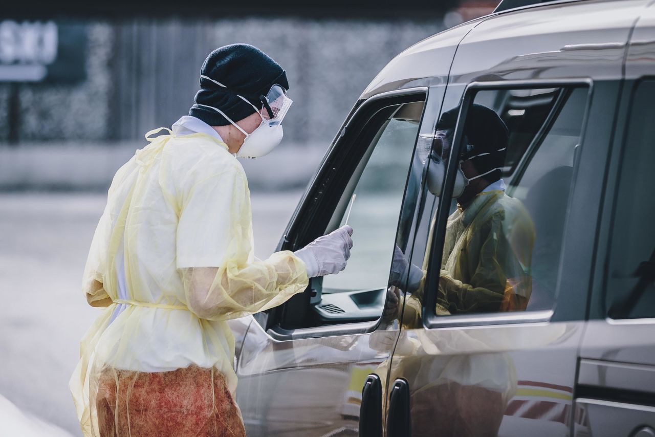 A Red Cross employee takes a swab from a motorist to test for coronavirus at a drive-in testing station in Schuettdorf, Austria on March 26.