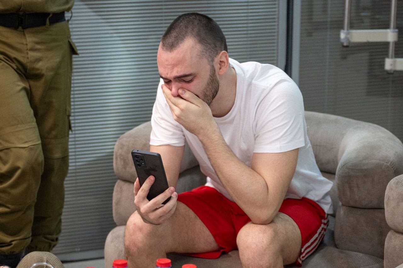 In an image supplied by the Israeli Army, Andrey Kozlov, a rescued hostage, reacts as he uses his phone, after the military said that Israeli forces have rescued four hostages alive from the central Gaza Strip, in Ramat Gan, Israel, on June 8.