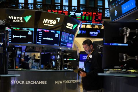 Traders work on the floor of the New York Stock Exchange at the opening bell on August 5 at Wall Street in New York City.