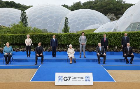 Britain's Queen Elizabeth II, center, poses for a photograph with, from left, Germany's Chancellor Angela Merkel, President of the European Commission Ursula von der Leyen, France's President Emmanuel Macron, Japan's Prime Minister Yoshihide Suga, Canada's Prime Minister Justin Trudeau, Britain's Prime Minister Boris Johnson , Italy's Prime minister Mario Draghi, President of the European Council Charles Michel and US President Joe Biden, during an evening reception at The Eden Project in England on June 11.