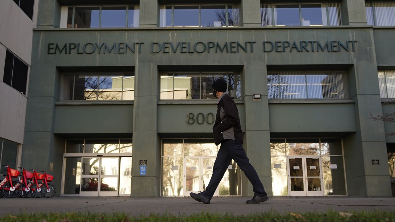 A person passes the office of the California Employment Development Department in Sacramento, California, on December 18, 2020.