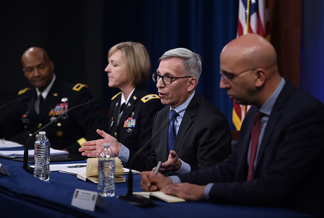 Dr. Nelson Michael, director of the Center for Infectious Diseases Research at Walter Reed Army Institute of Research,second from right, speaks during a news conference on the coronavirus at the Pentagon on Thursday.