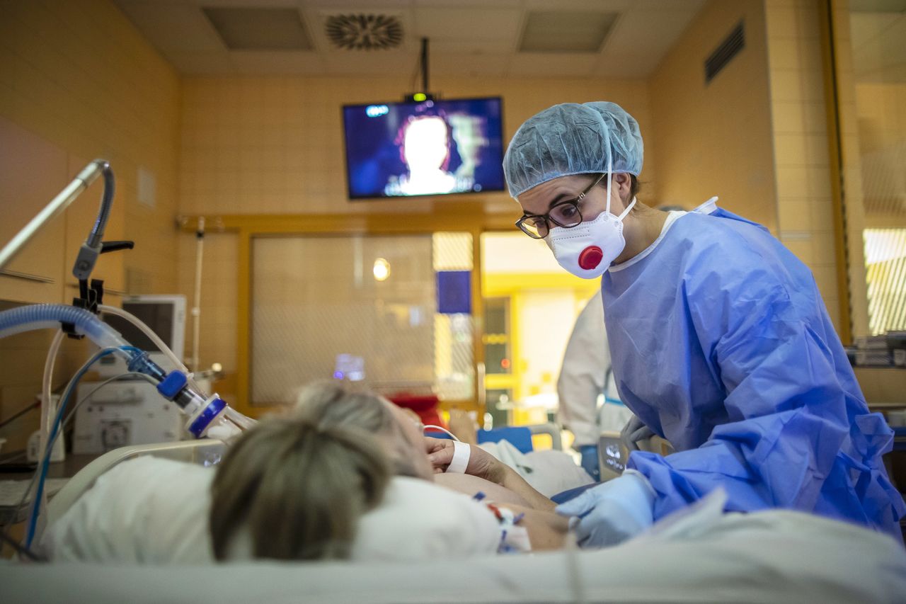 A medical worker treats a patient infected with the coronavirus at the intensive care unit of the General University Hospital on December 24, in Prague, Czech Republic.