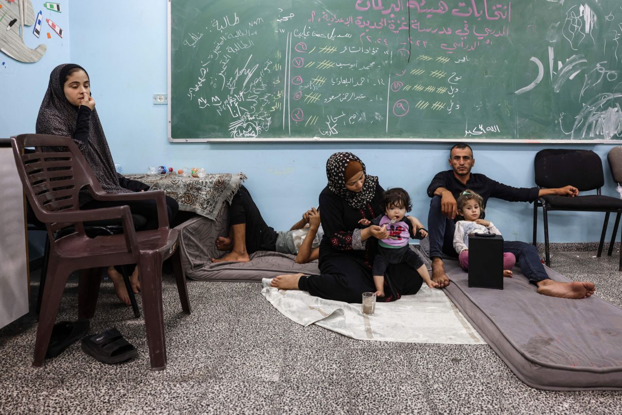 Palestinians fleeing Israeli air strikes take refuge in a school run by the United Nations?in Gaza City on October 8, 2023.