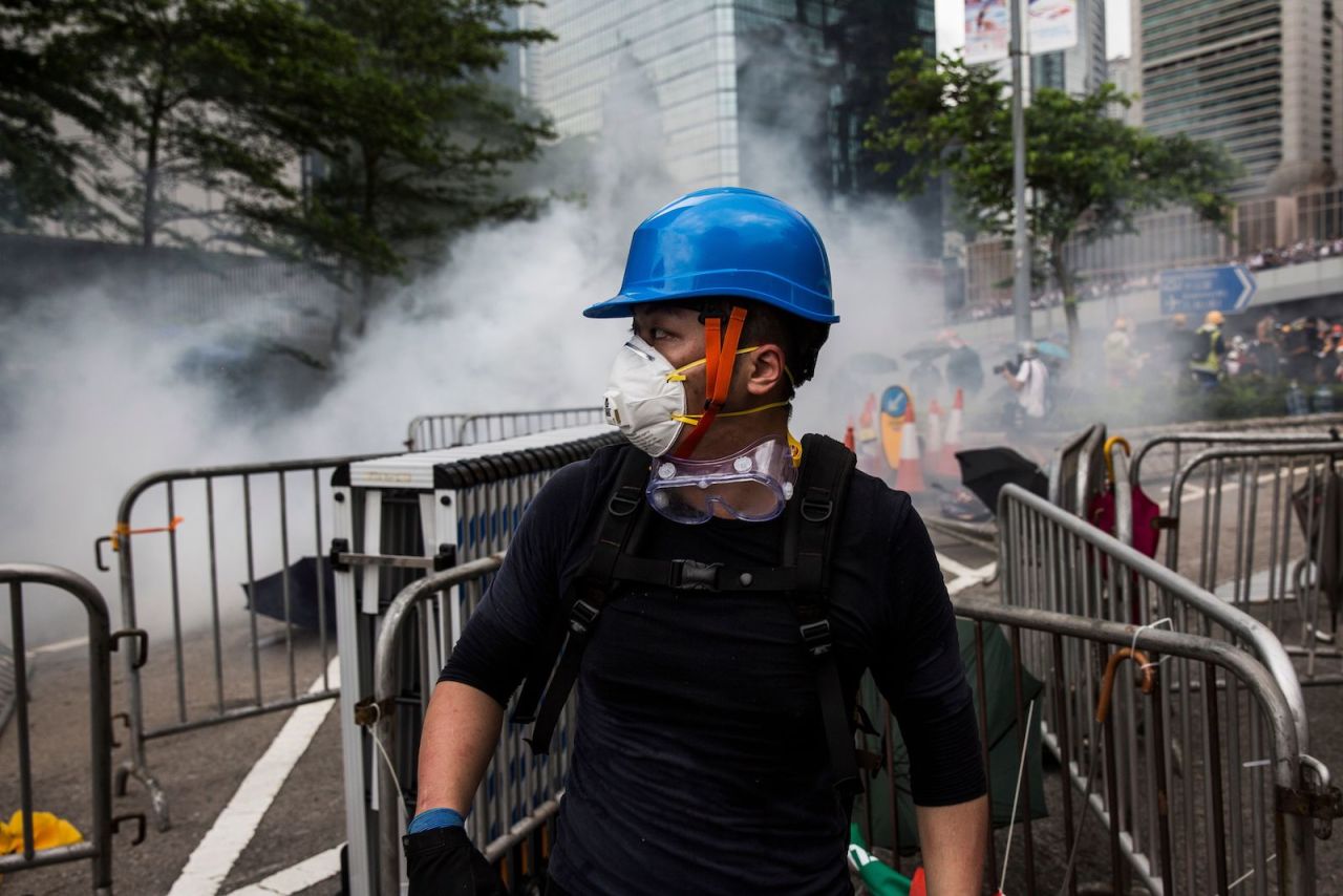 A protester wearing a mask reacts after police fired tear gas during demonstrations outside the Legislative Council Complex in Hong Kong on June 12.