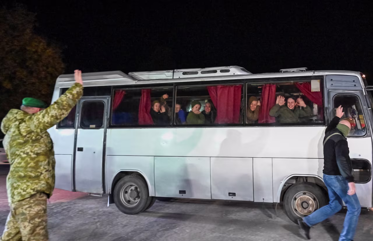 Ukrainian prisoners of war look out of a bus window as they arrive in Zaporizhzhia on October 17, 2022.