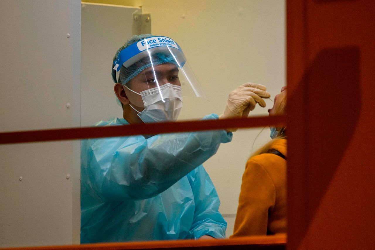 A resident receives a mandatory Covid-19 test by a health worker at a testing site in the Jordan area of the Yau Tsim Mong district of Kowloon in Hong Kong, on January 22.