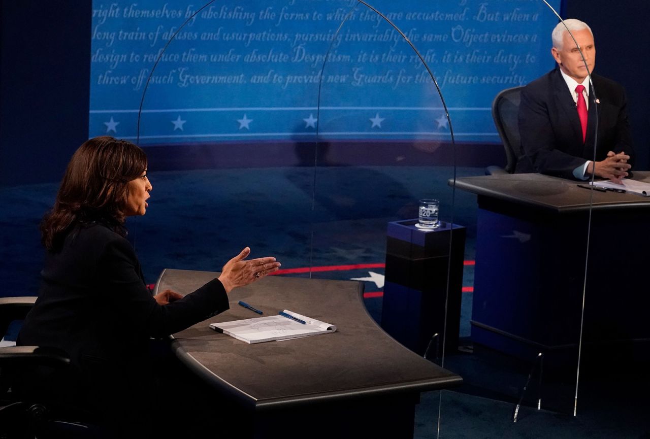 Vice President Mike Pence listens as Democratic vice presidential nominee Kamala Harris speaks during the vice presidential debate on Wednesday in Salt Lake City. 