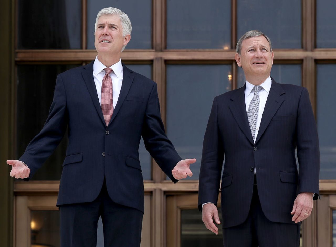 Supreme Court Justice Neil Gorsuch (L) talks with Chief Justice John Roberts (R) on the steps of the Supreme Court on June 15, 2017 in Washington, DC.