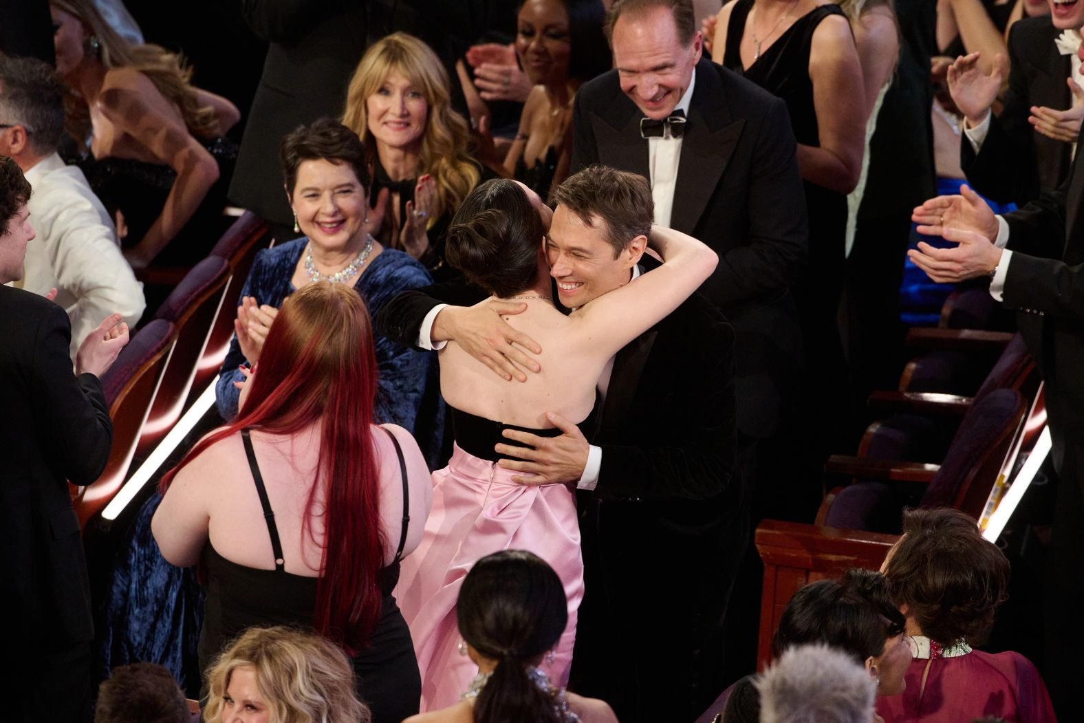 Baker hugs Madison before accepting the <a href="https://www.cnn.com/entertainment/live-news/oscars-academy-awards-03-02-25#cm7scqhfn00083b6np5u1r8q8">best original screenplay Oscar</a>.