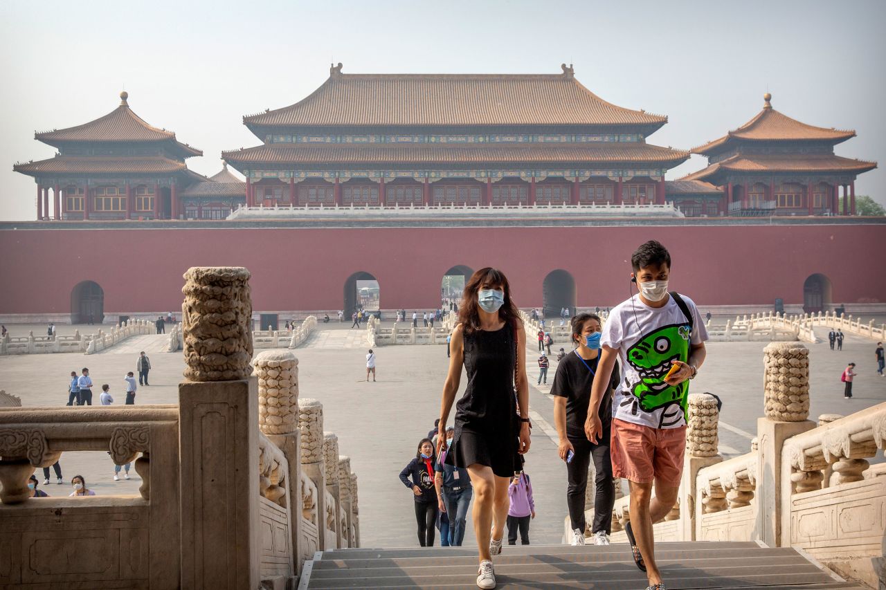 Visitors wearing face masks to protect against the new coronavirus walk through the Forbidden City in Beijing, May 1.