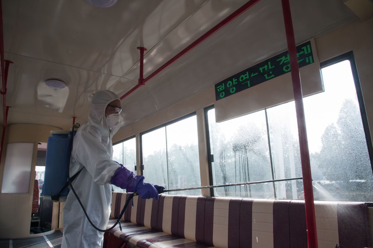 An official from the Mangyongdae District emergency anti-epidemic headquarters disinfects a tramcar at the Songsan Tram Station in Pyongyang.